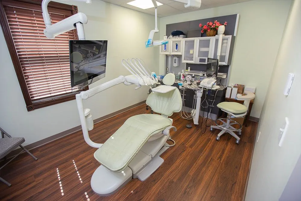 A clean, modern operatory at Independence Family Dentistry with a wall-mounted monitor and digital imaging